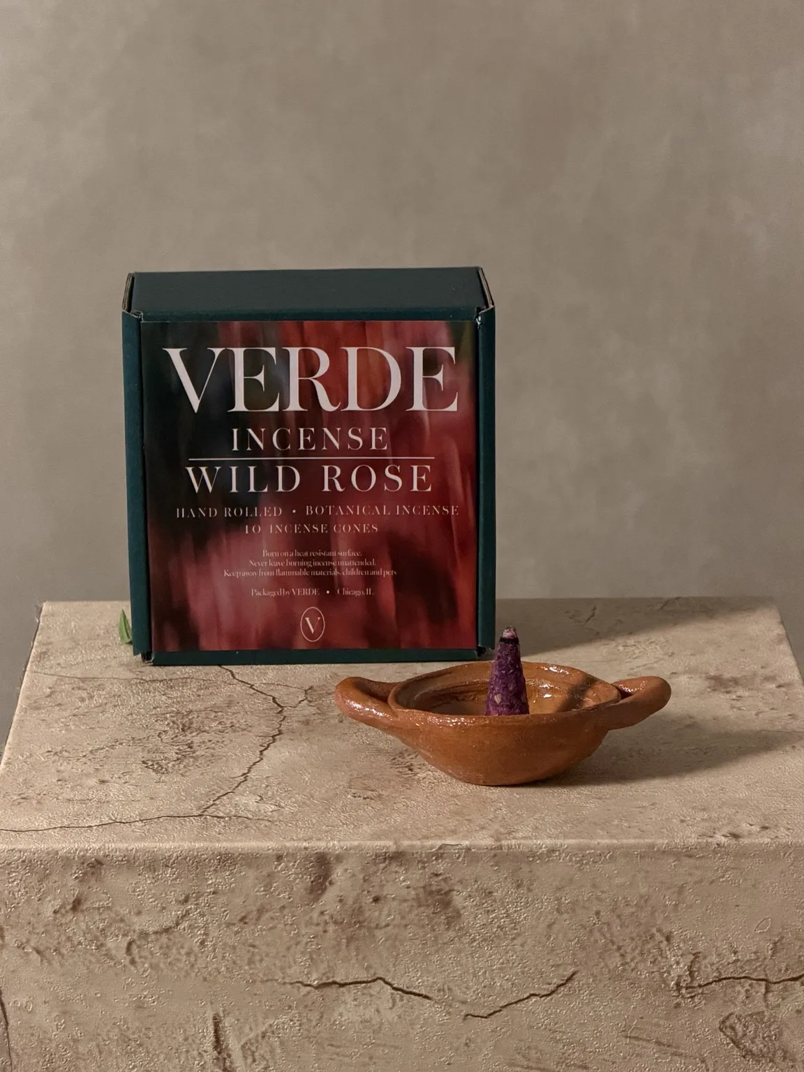 VERDE Wild Rose incense box beside a terracotta incense dish on a stone plinth
